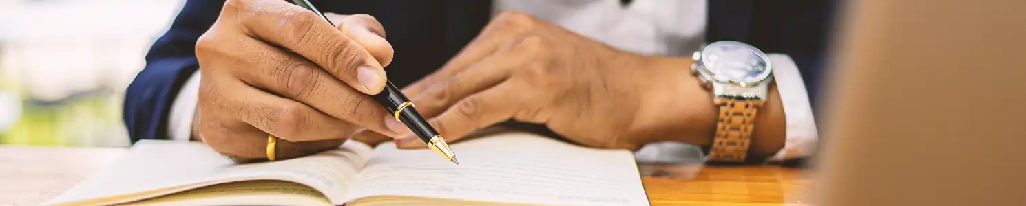 A lawyer pointing to a book with a pen