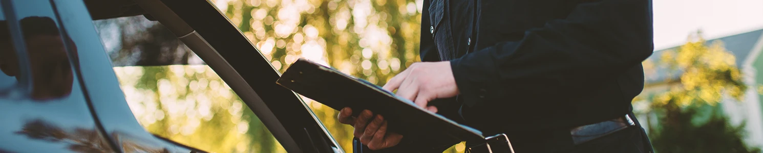 A police officer writing a ticket to a driver