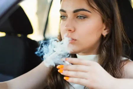 A photo of a girl smoking marijuana inside the car