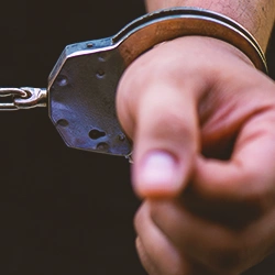 A person's wrist in handcuffs