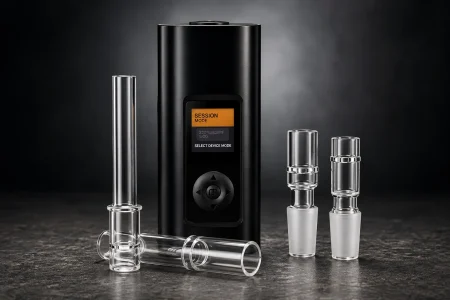 Black Arizer Solo III vaporizer with glass accessories displayed on a dark studio surface.