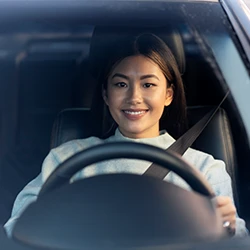 A teen driving her car while avoiding distractions