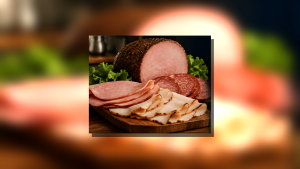 Assorted sliced deli meats arranged on a wooden board