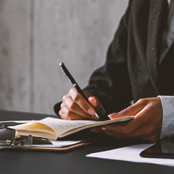 A lawyer writing down on a book