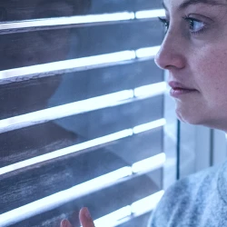 Worried woman staring out the window