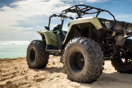 A CFMOTO CFORCE 800 ATV parked on a beach