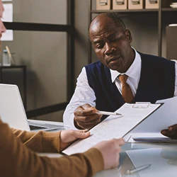 A lawyer explaining to a client the camp lejeune liver cancer lawsuit
