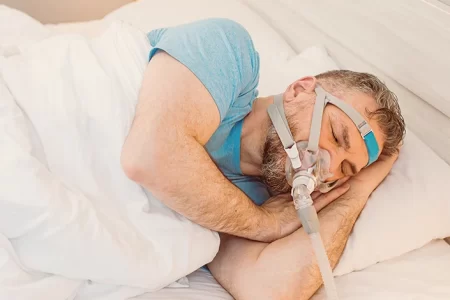 A man sleeping while using CPAP Machine