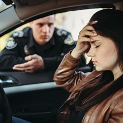 A police talking to a woman due to drugged driving