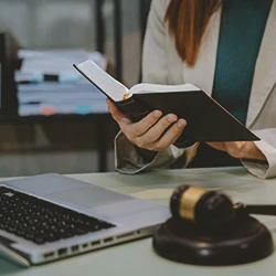 An attorney reading a law book on defenses