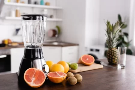 blender and fruits on the table