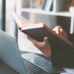 A lawyer holding and reading a book