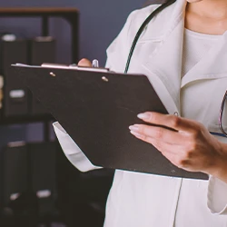 A doctor looking at a clipboard