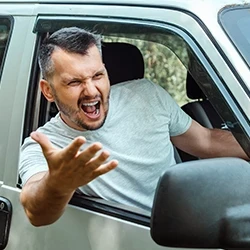 A mad driver doing gestures outside his car window
