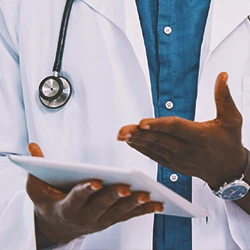 A doctor pointing to a clipboard