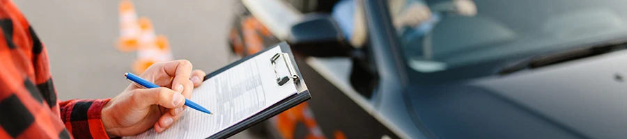 An instructor grading his student driving