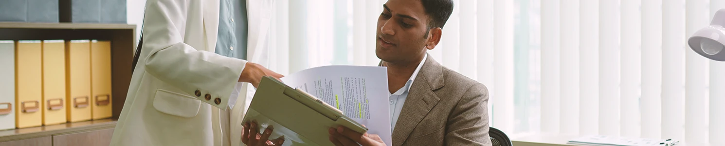 An office worker looking at a clipboard