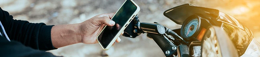 A man texting while driving his motorcycle