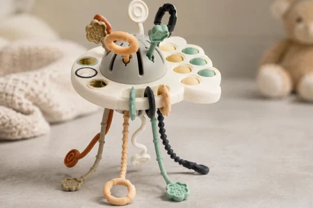 GOPO pull-string teething toy with colorful silicone strings displayed in a softly lit nursery setting.