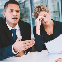 A lawyer having a debate with someone with a client beside him