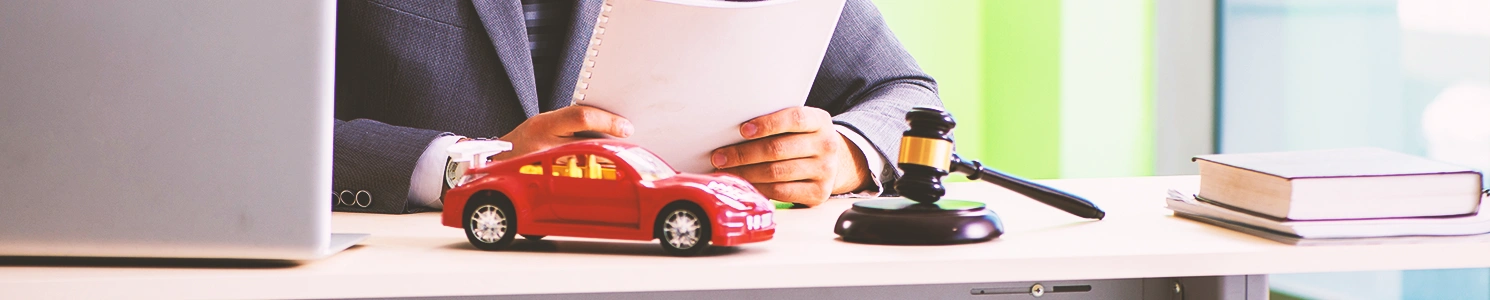 A lawyer with a small car on his desk