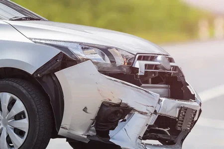 A damaged parked car because of a hit and run incident