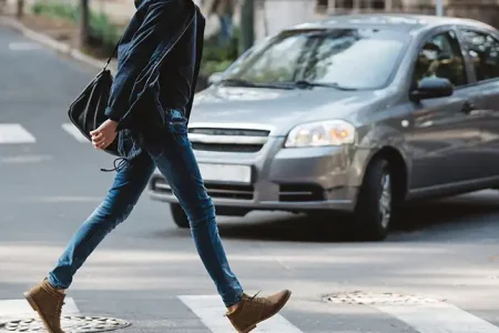 a photo of a man crossing the street