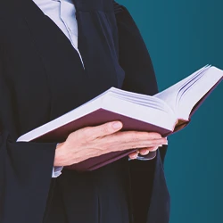 A lawyer holding a book while standinfg up