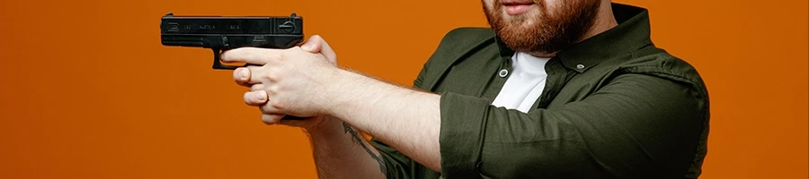 A man pointing a gun who is about to commit a murder
