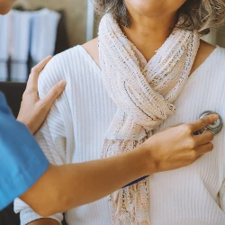 A doctor looking for signs of cancer on a patient