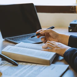 A lawyer reading and writing on a book