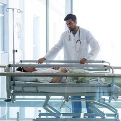 A doctor checking a patient in a hospital bed 