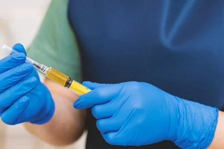 A doctor holding a steroid injection in a hospital