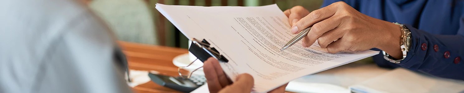 An image of a lawyer pointing at a paperwork