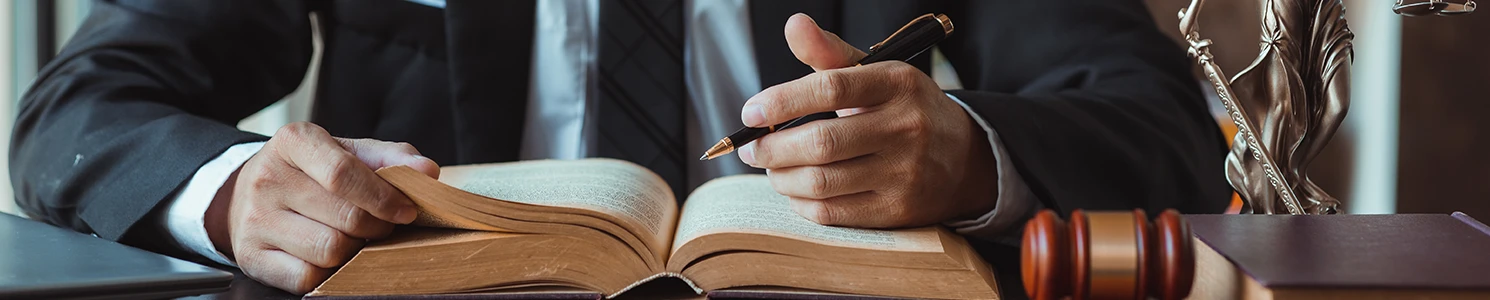 A close up image of a lawyer studying a book