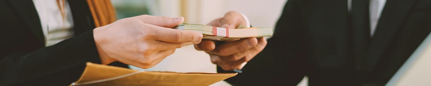 A lawyer and client passing money to each other
