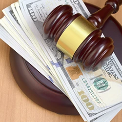 A top view of gavel and dollar bills