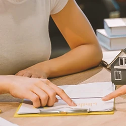 A person pointing at paperwork