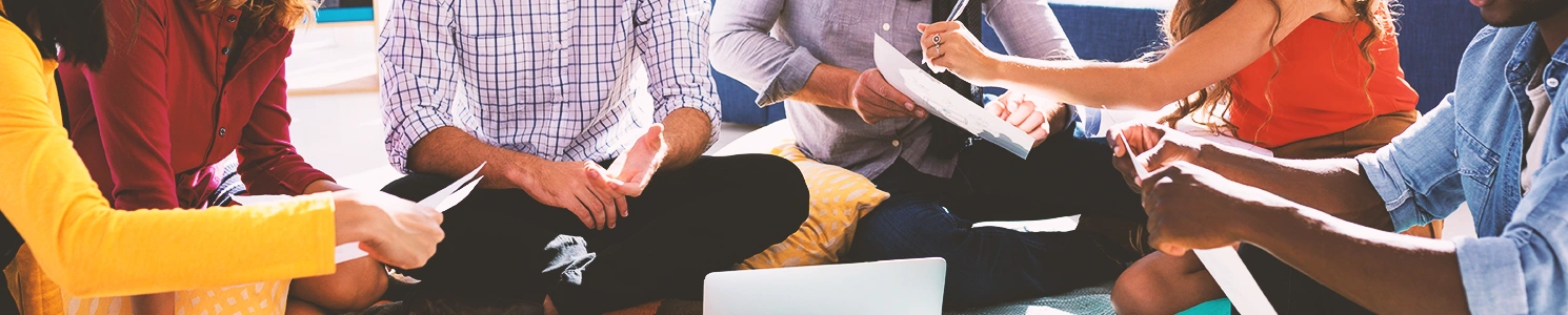 Five colleagues discussing on a laptop