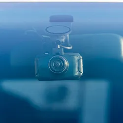 A dash cam hanging inside a car 