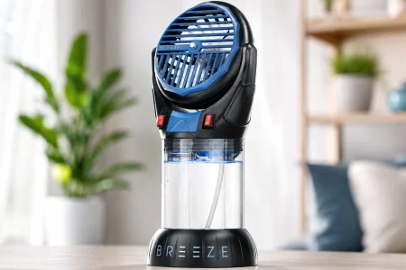 IcyBreeze Buddy portable misting fan with a clear water reservoir displayed on a table in a bright living room.