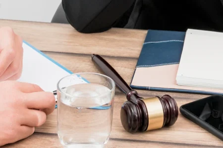 lawyers writing lawsuit report in meeting