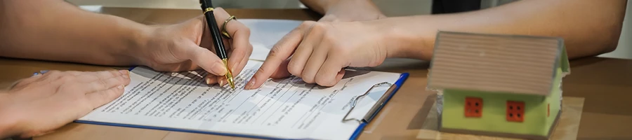 A person signing important papers