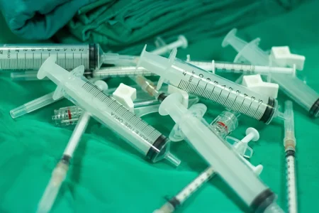 A top view of Invega Syringes on a green table