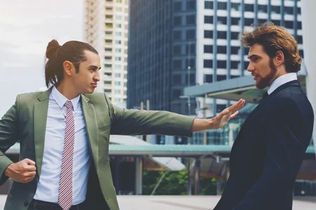 A business man pushing someone outside, is it assault