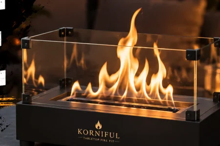 KORNIFUL-style tabletop fire pit with glass windshields and an open flame displayed on a modern patio table.
