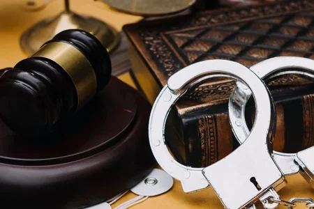An image of court gavel and handcuffs related to larceny and burglary