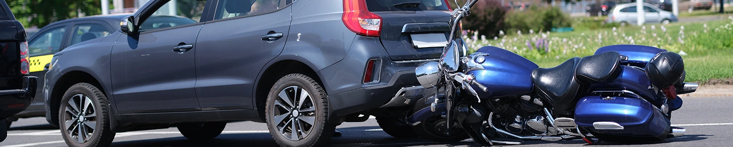 A motorcycle bumped onto a car 