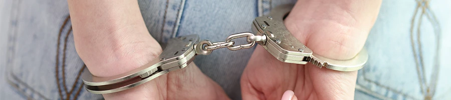 A close up shot of a person in handcuffs