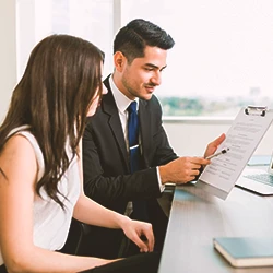 A lawyer talking to a client about paperwork